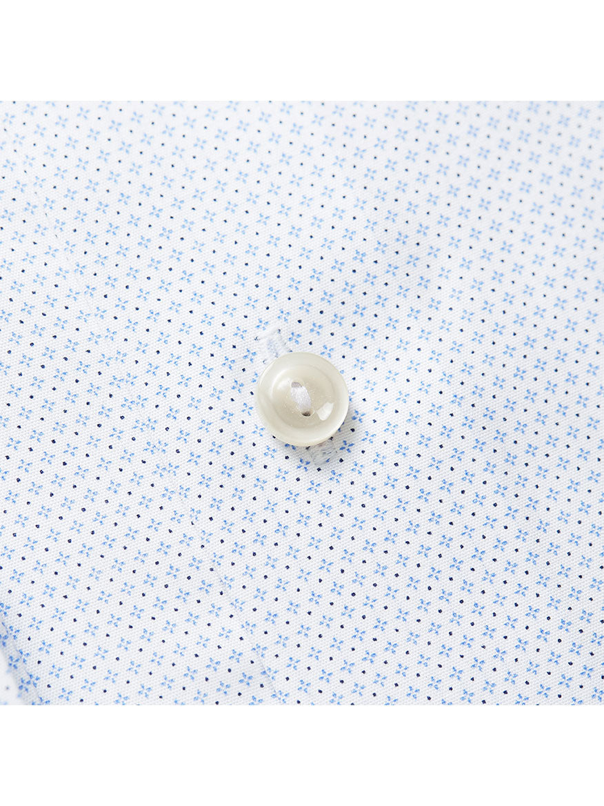 Close-up of a white shirt fabric with small blue dots and a white button sewn in the center, showcasing Eton Contemporary Fit Sky Blue Micro Print Dress Shirt that exemplifies a timeless wardrobe staple.