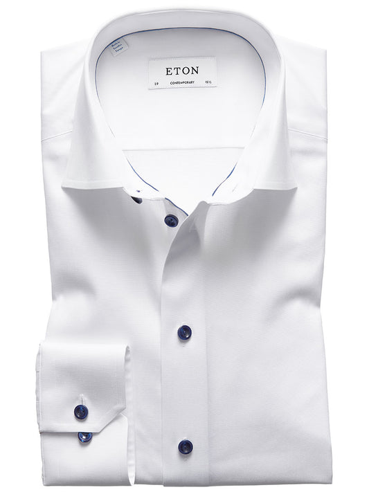 A white Eton dress shirt with blue buttons, displayed flat, featuring signature twill in a contemporary fit.