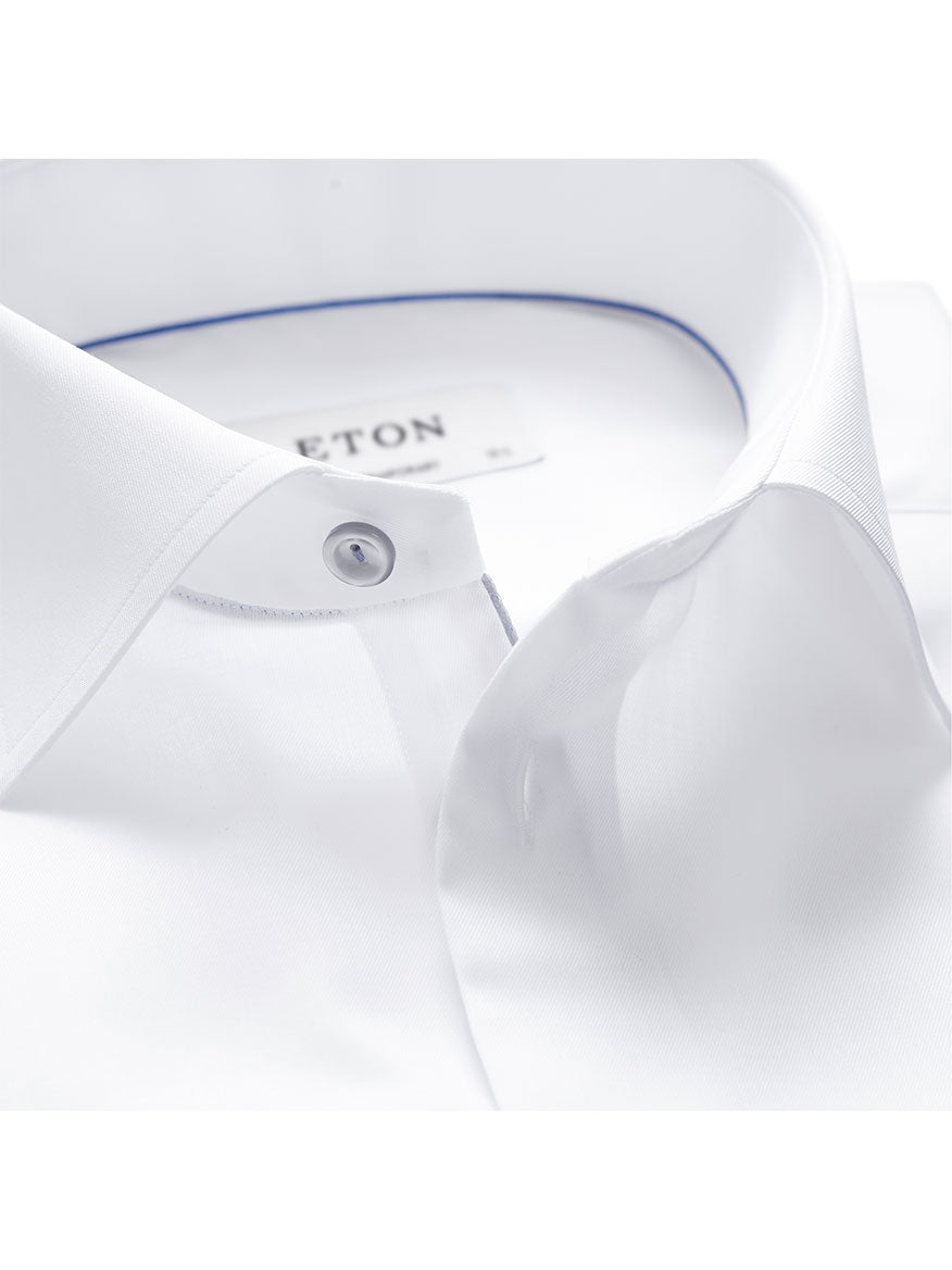 Close-up image of a white dress shirt collar with grey details and button accents, showcasing Eton's signature twill. The label inside the collar is partially visible. The product featured is the Eton Contemporary Fit White Twill Dress Shirt With Grey Details.