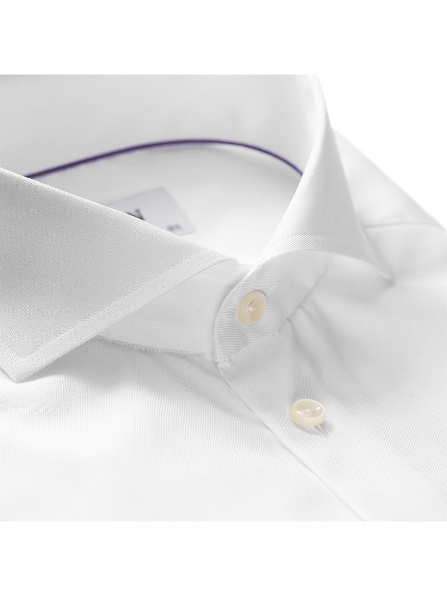 Close-up of a neatly folded wrinkle-free shirt with a crisp collar and two visible buttons. The white dress shirt boasts Signature twill fabric and features a purple trim on the inner collar, perfect for a polished business look. This is the Eton Contemporary Fit White Extreme Cut Away Dress Shirt.