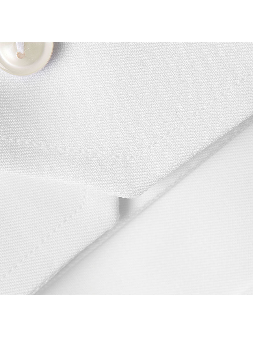 Close-up of a white textured fabric with a beige button and folded edges visible, showcasing the refined elegance of Eton Contemporary Fit White Extreme Cut Away Dress Shirt that's perfect for a wrinkle-free shirt with a business look.