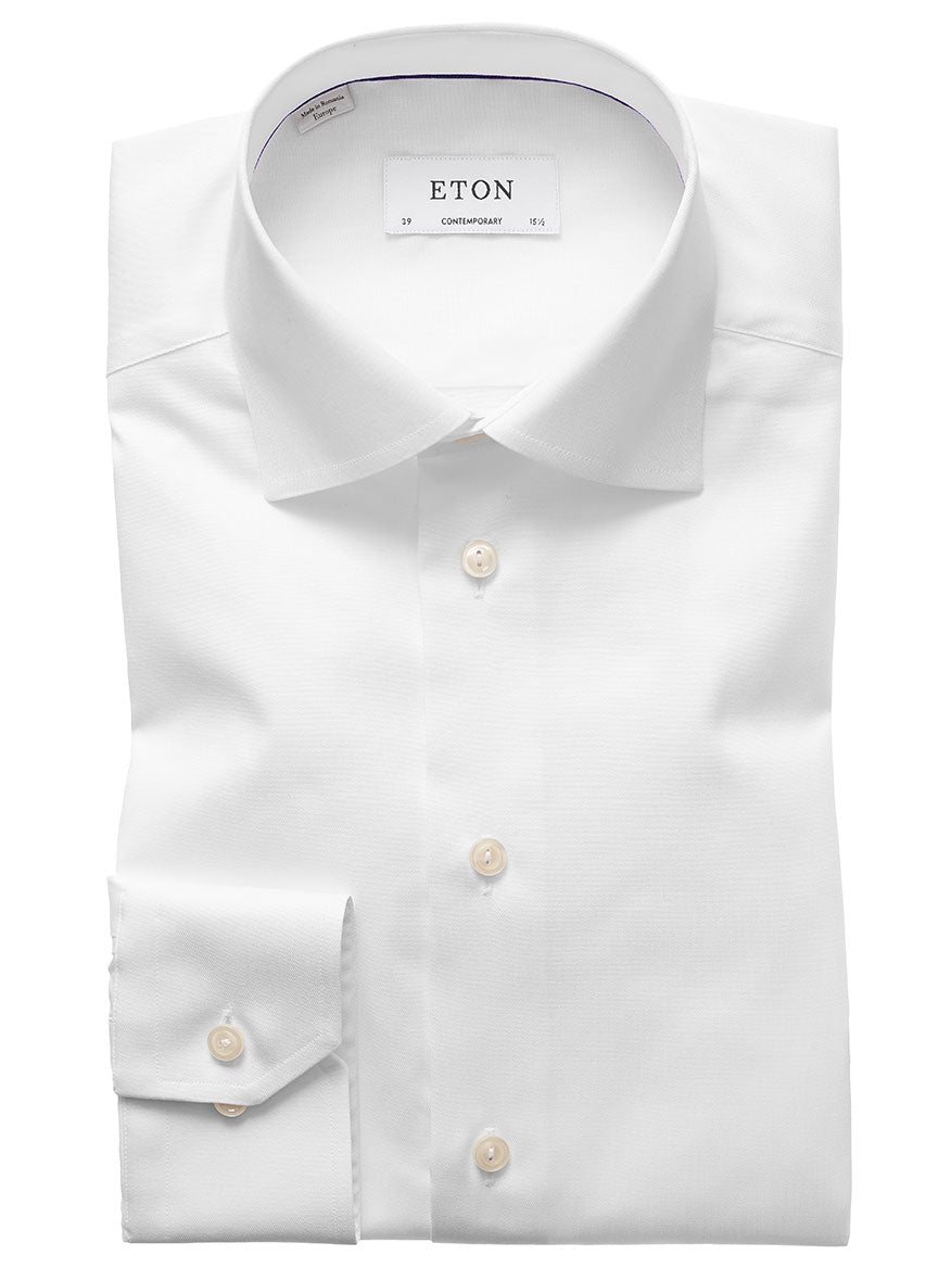 The Eton Contemporary Fit White Signature Twill Dress Shirt is a neatly folded dress shirt with a classic collar and buttons, designed to showcase a contemporary fit. Additionally, this versatile shirt is crafted to remain wrinkle-free throughout your busy day.