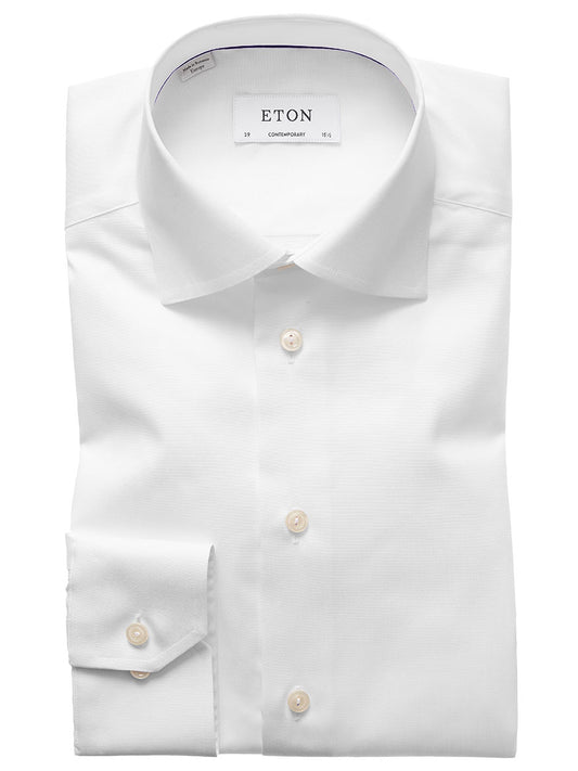 The Eton Contemporary Fit White Signature Twill Dress Shirt is a neatly folded dress shirt with a classic collar and buttons, designed to showcase a contemporary fit. Additionally, this versatile shirt is crafted to remain wrinkle-free throughout your busy day.