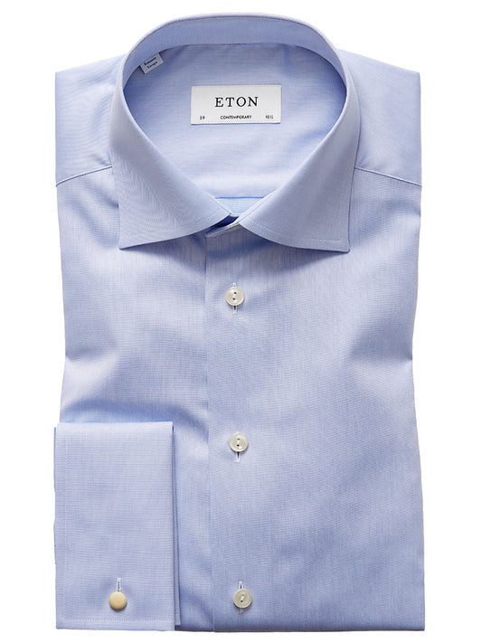 A neatly folded, wrinkle-free Eton Contemporary Fit Light Blue French Cuff Dress Shirt with a label displaying "ETON" and size details. The shirt features a pointed collar, French cuffs, and is buttoned down the front.