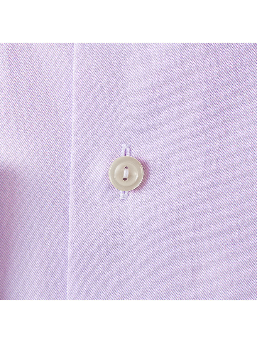 Close-up image of a white button sewn onto the light pink wrinkle-free fabric of the Eton Slim Fit Purple Signature Twill Dress Shirt.