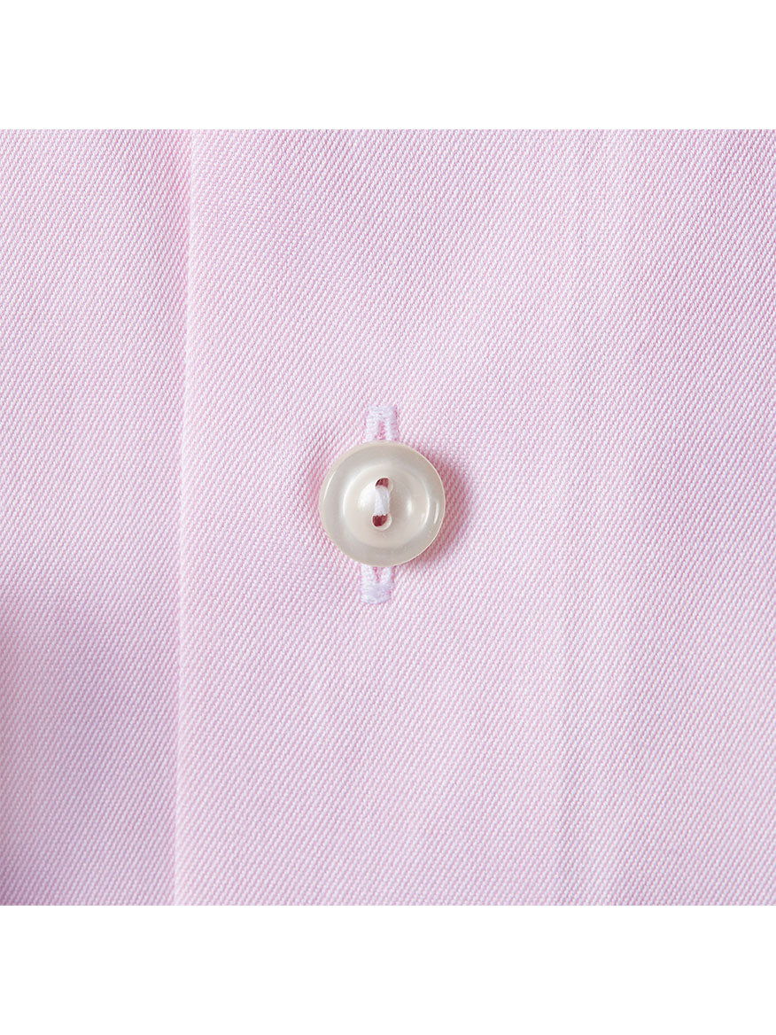 Close-up of a white button on light pink fabric with a fine diagonal weave, from the Eton Slim Fit Pink Signature Twill Dress Shirt.