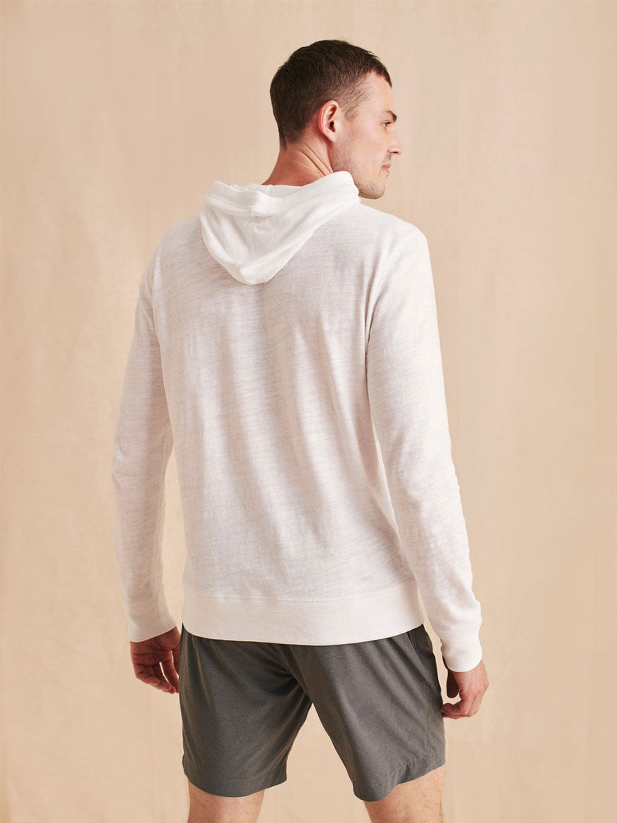 The back of a man wearing a Faherty Brand Slub Cotton Hoodie in White.