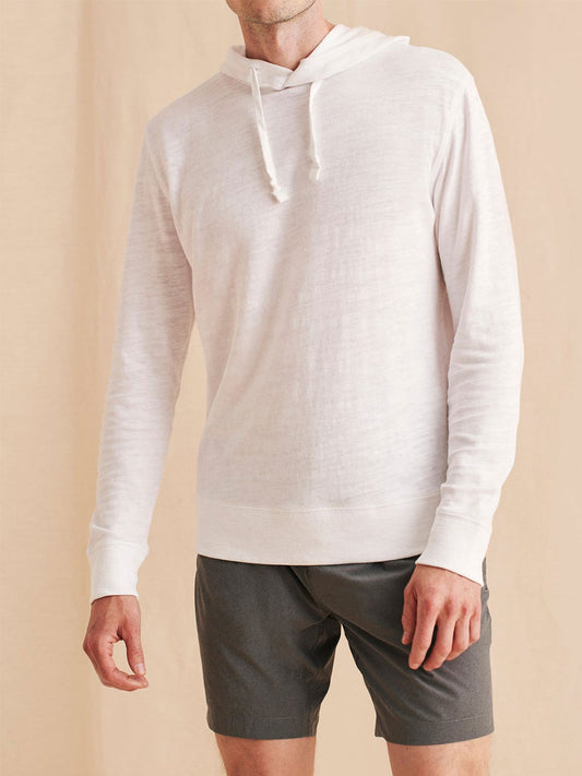 A man wearing a Faherty Brand Slub Cotton Hoodie in White.