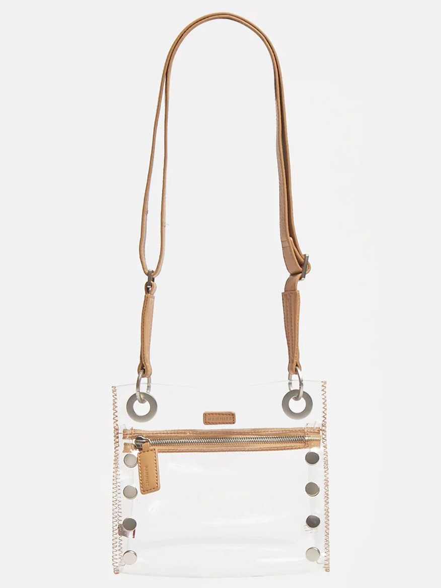 Clear TPU and Hammitt Los Angeles Tony Small Crossbody Bag in Clear Toast Tan with an adjustable strap, featuring a front zipper and circular metal accents.