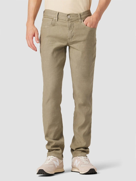A person wearing Hudson Blake Slim Straight Twill Pant in Safari and white sneakers, with a focus on the pants from the waist to the shoes.