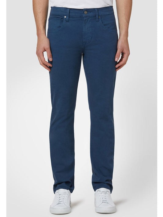 A person wearing Hudson Blake Slim Straight Twill Pant in Navy with a slim tapered leg and white sneakers.