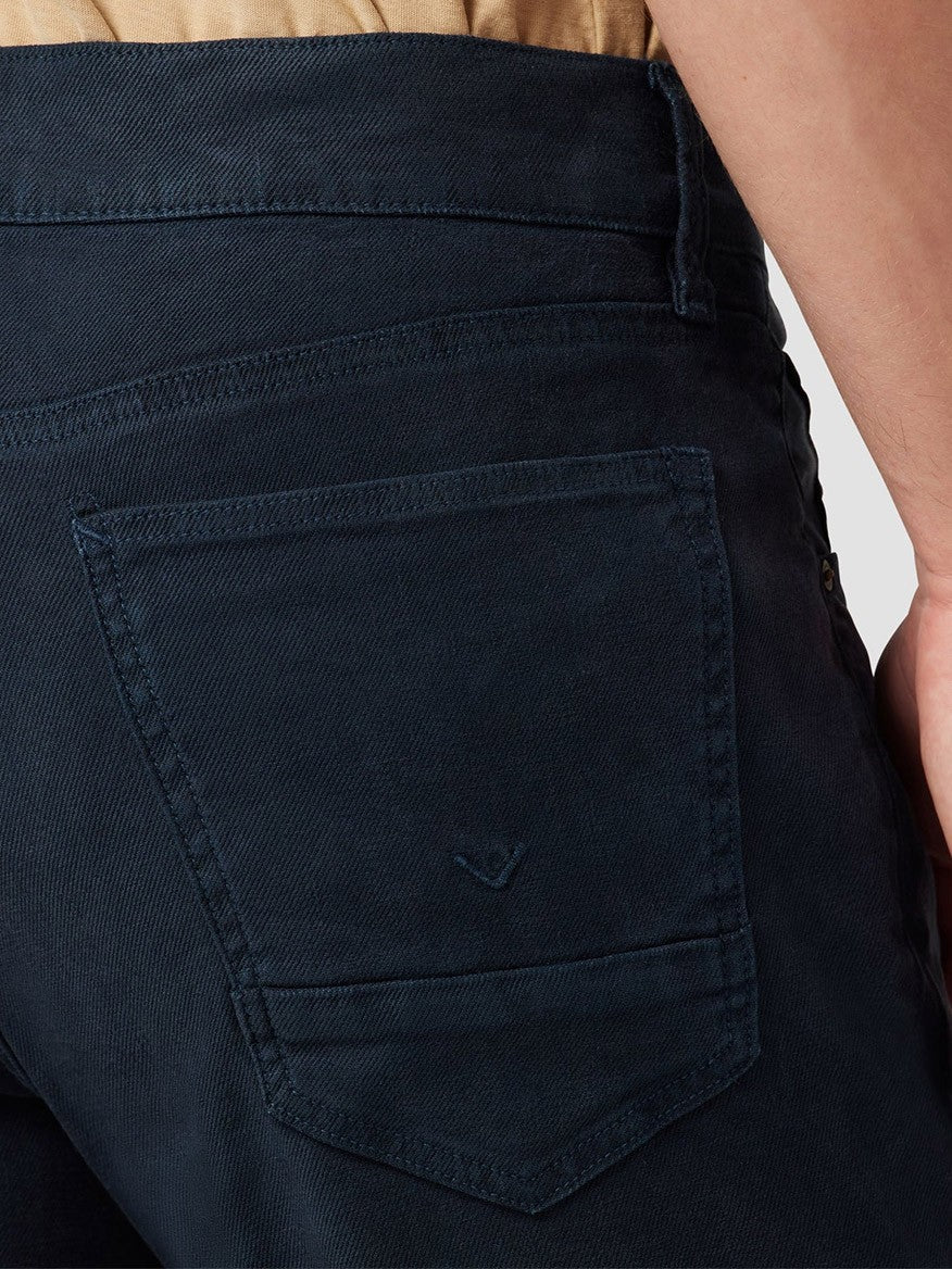 Close-up of a Hudson Blake Slim Straight Twill Pant in Night Blue back pocket, showing detailed stitching and a small embroidered logo.