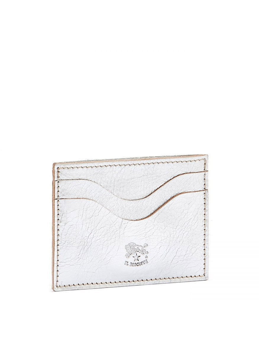 A Il Bisonte Baratti Card Case in Metallic Silver Leather wallet with a wavy design and embossed logo on a white background.