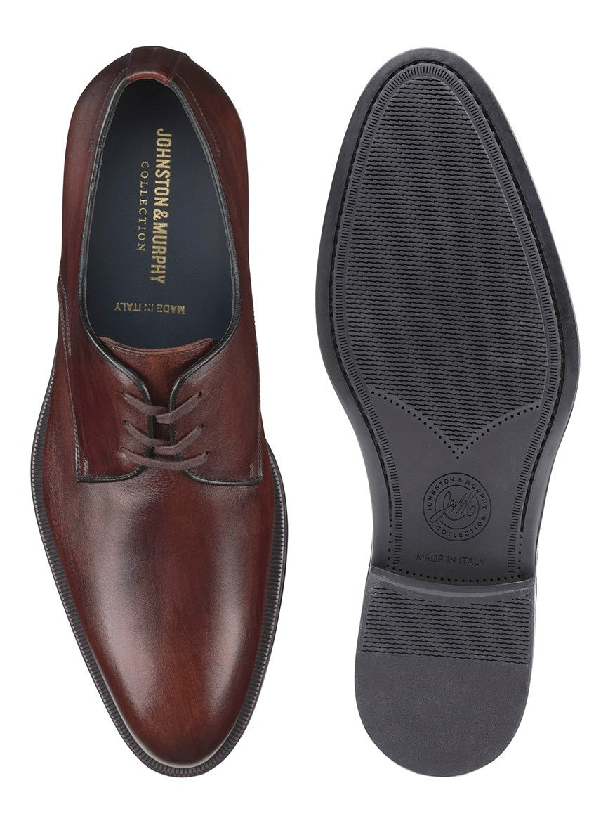 A pair of J & M Collection Flynch Cap Toe in Mahogany Italian Calfskin derby shoes from Italy on a white background.