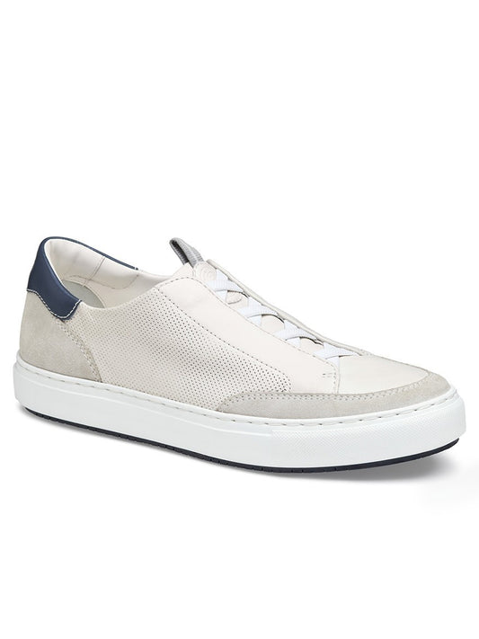 The J & M Collection Anson Stretch Lace-to-Toe features a light beige sheepskin suede upper, perforated side panels, white sole, and dark blue heel accent.