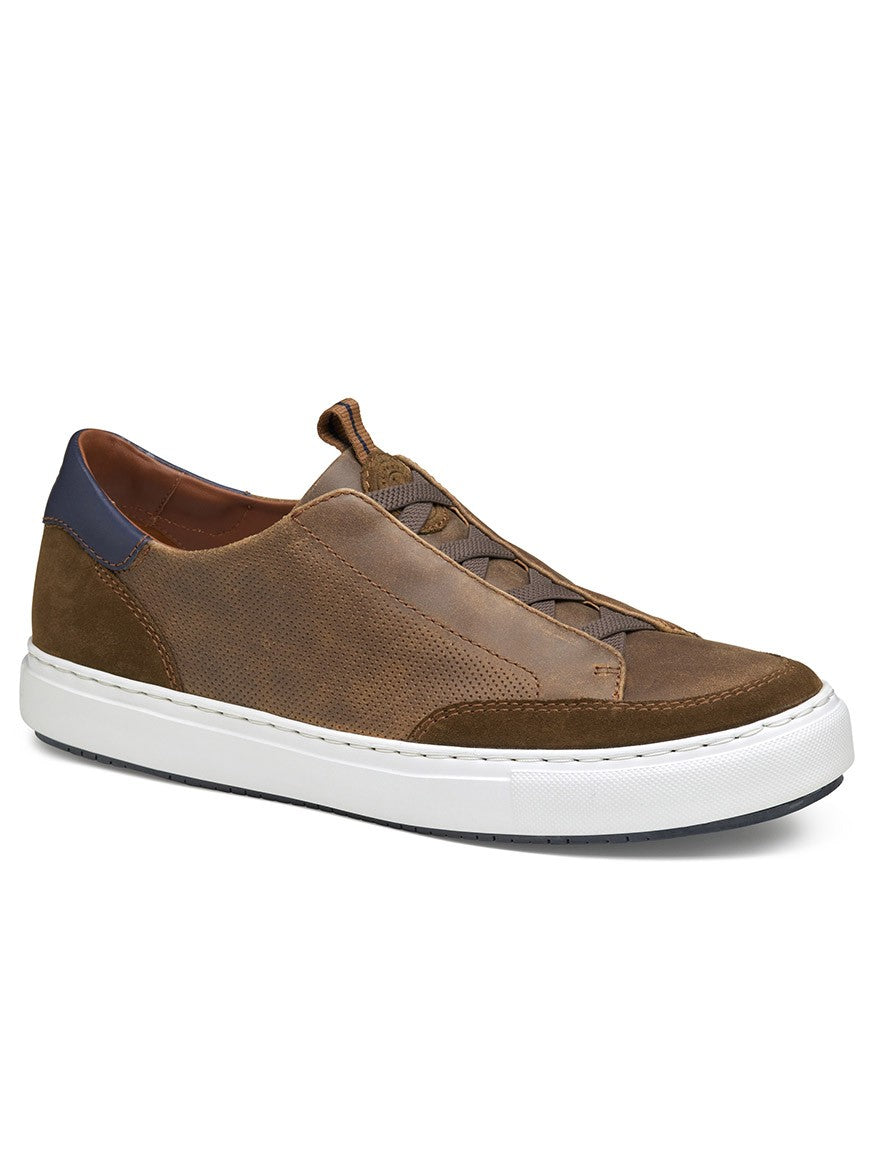 The J & M Collection Anson Stretch Lace-to-Toe in Brown English Suede/Sheepskin features a retro design with a white sole, navy heel detail, and elastic no-tie laces, displayed at a three-quarter angle on a white background.