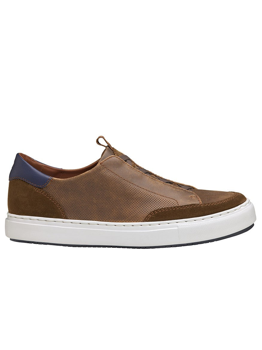 The J & M Collection Anson Stretch Lace-to-Toe sneaker in Brown English suede and sheepskin features a white rubber sole and blue heel accent, displayed in side view against a white background.