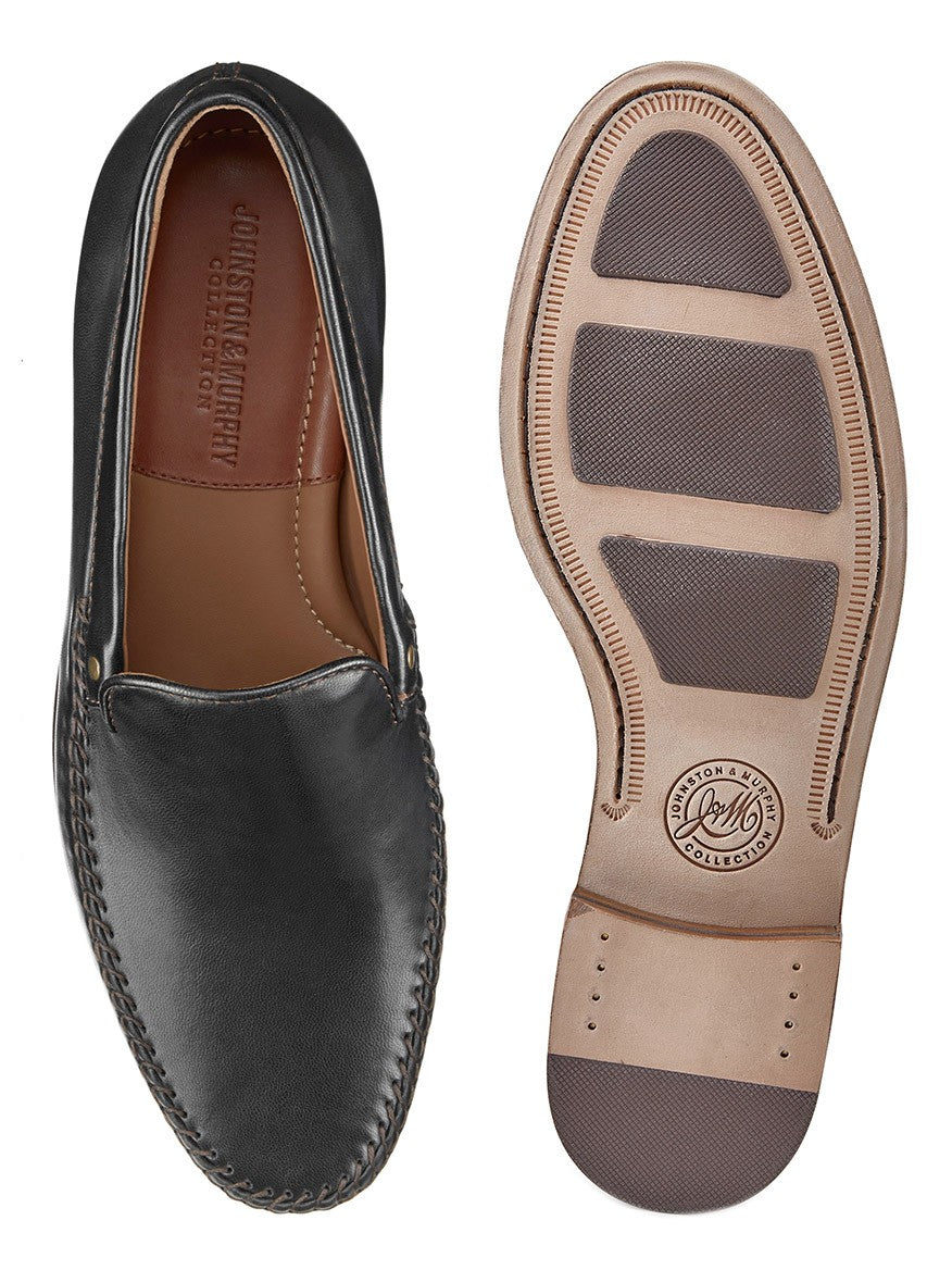 A pair of J & M Collection Baldwin Whipstitch Venetian black loafers with a brown sole made from sheepskin leather.