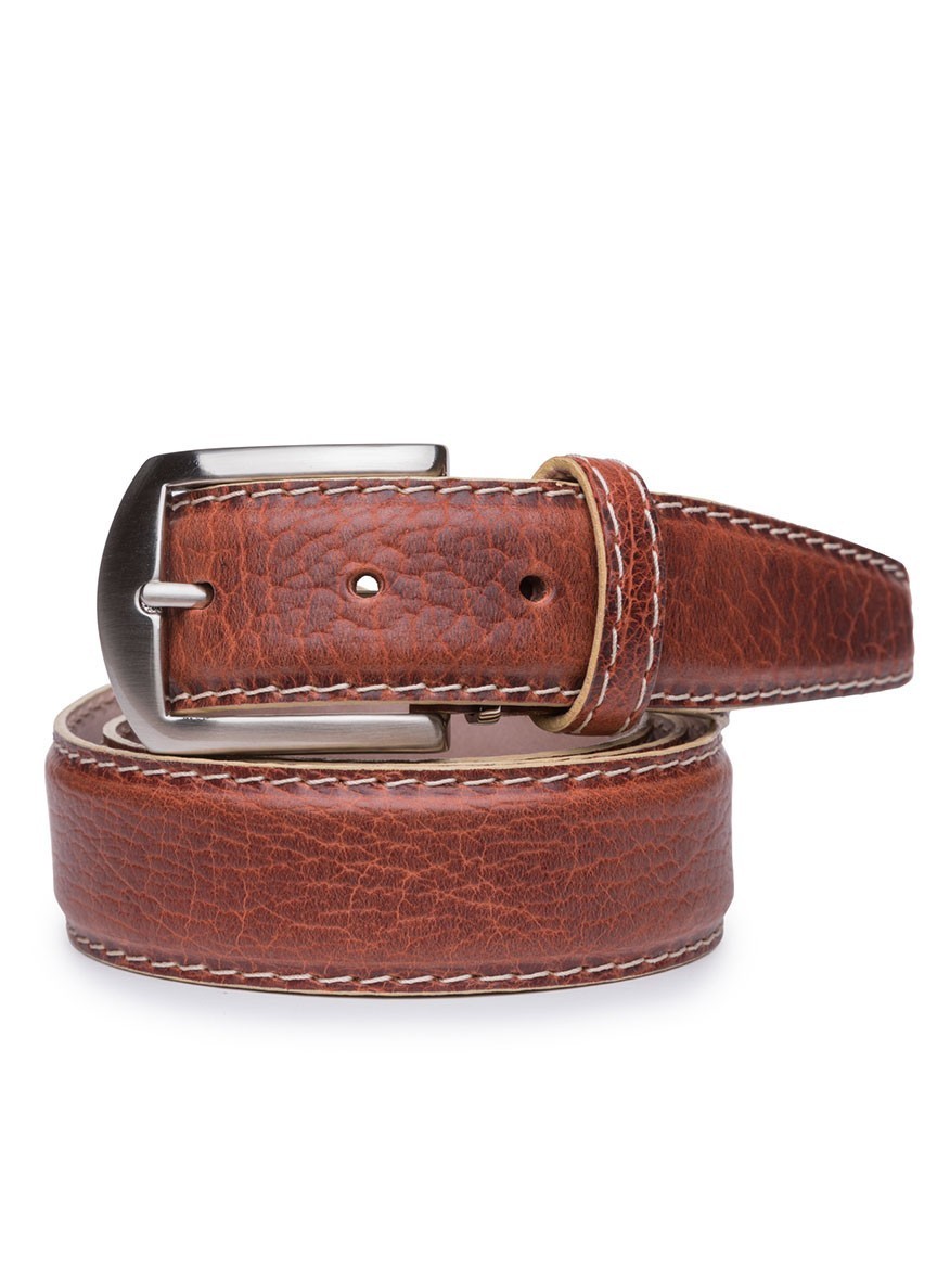 The LEN Belts American Bison Belt in Cognac features a silver buckle, visible beige stitching along the edges, and is rolled up. Crafted from American Bison leather, this belt is made in the USA and ideal for casual wear.