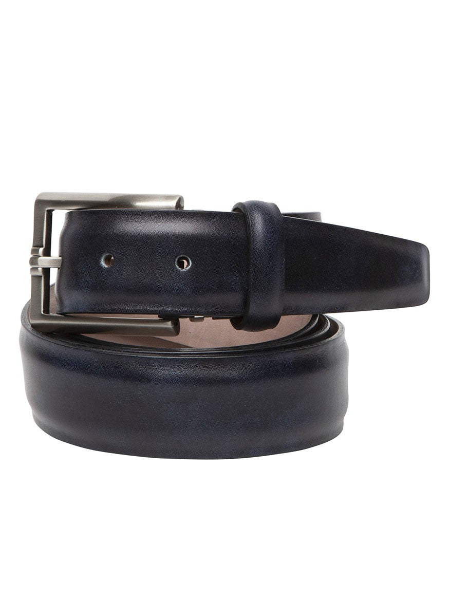 A navy leather belt with a silver buckle, crafted through a vegetable-dyed process, is coiled on a white background.