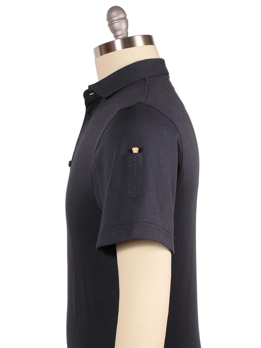 Side view of a mannequin wearing a short-sleeve, dark-colored Larrimor's Essential Performance Cotton Polo Sport Fit in Navy featuring a small golf-tee pocket on the left sleeve. The shirt boasts a sport fit and is crafted from performance tech fabric for optimal comfort and durability.