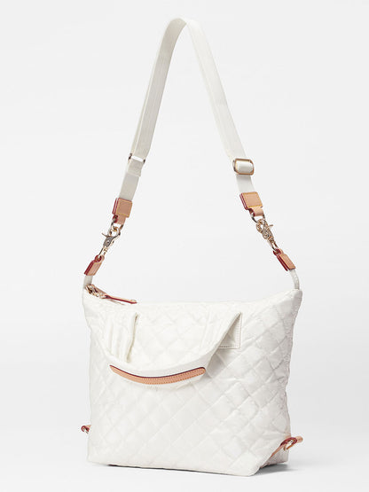 MZ Wallace Small Sutton Deluxe in Pearl Metallic Oxford with adjustable crossbody strap and exterior zipper pockets, displayed against a plain background.