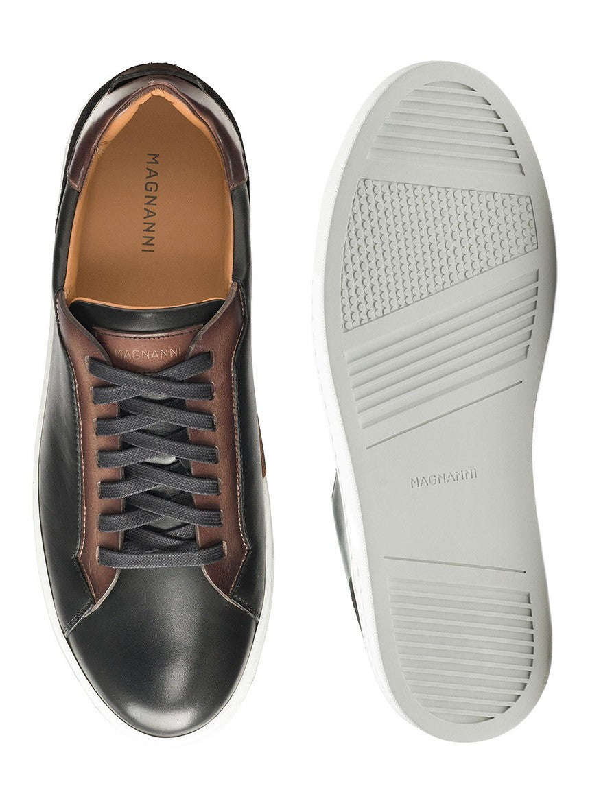 A luxury pair of Magnanni Amadeo sneakers with laces in black and brown.