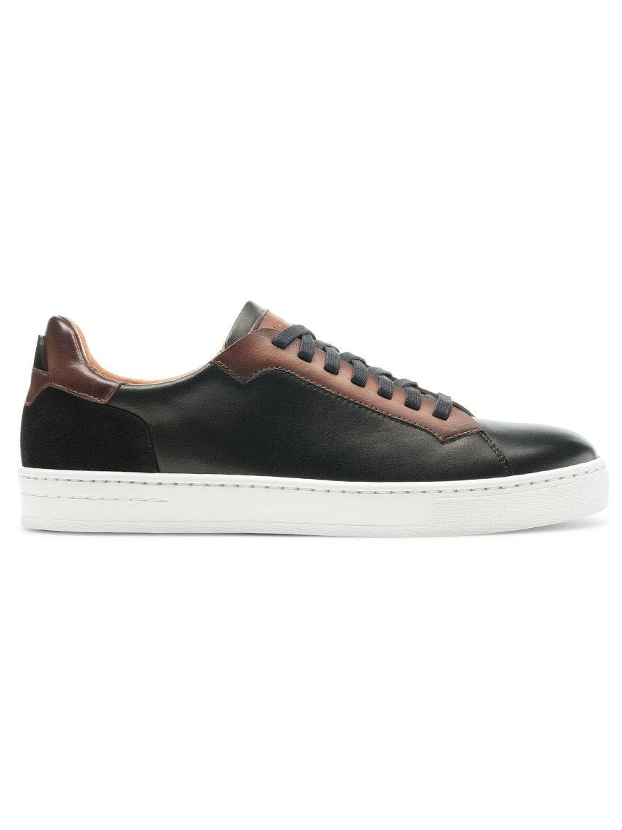 A Magnanni Amadeo in Black/Brown contemporary black leather sneaker with brown detailing, representing luxury.
