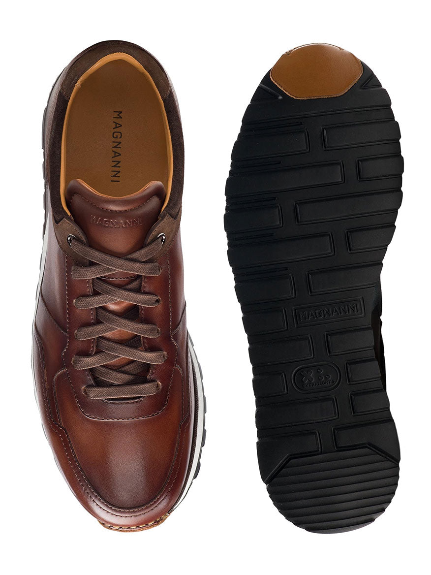 A pair of Magnanni Arco in Midbrown shoes with black soles.