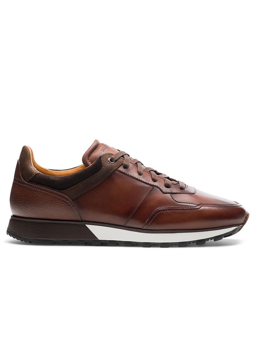 The Magnanni Arco in Midbrown is a retro-inspired men's brown leather sport sneaker with a runner sole.