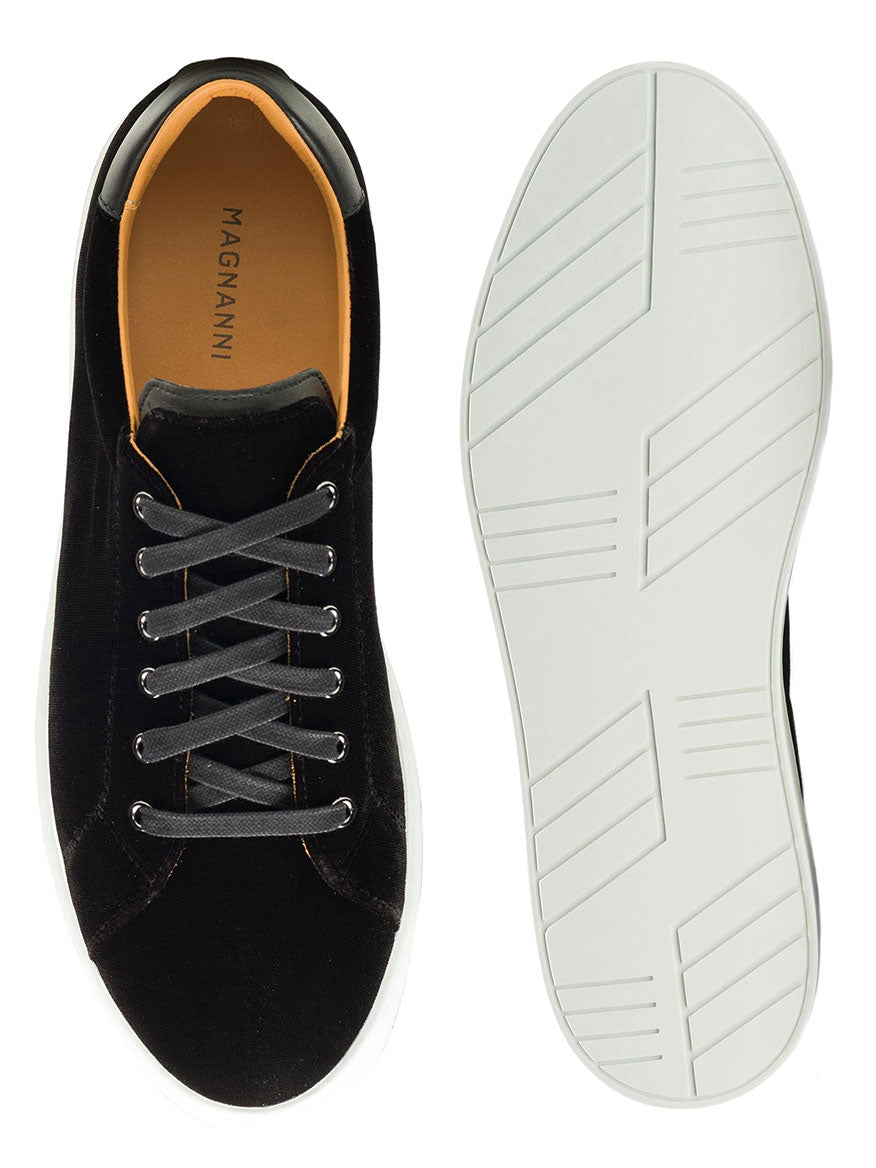 The Magnanni Dalia II in Black are black calfskin fashion sneakers featuring gray laces, an orange interior, and white rubber soles, displayed from top and bottom views.