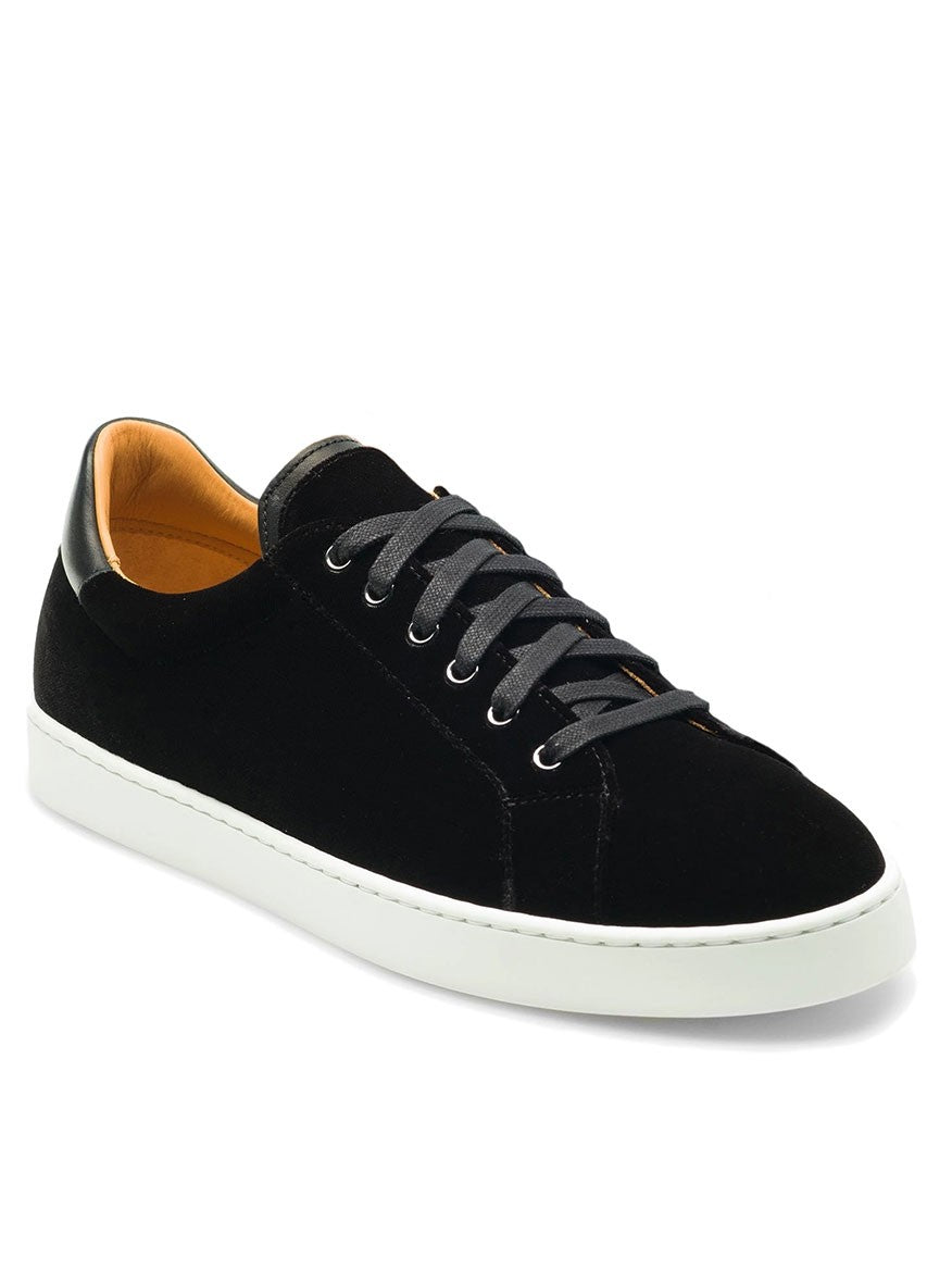 The Magnanni Dalia II in Black is a black suede fashion sneaker with black laces, metal eyelets, a white rubber sole, and a tan interior lining.
