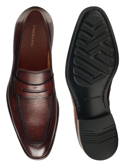A pair of Magnanni Matlin III in Midbrown loafers with brown leather and black soles.
