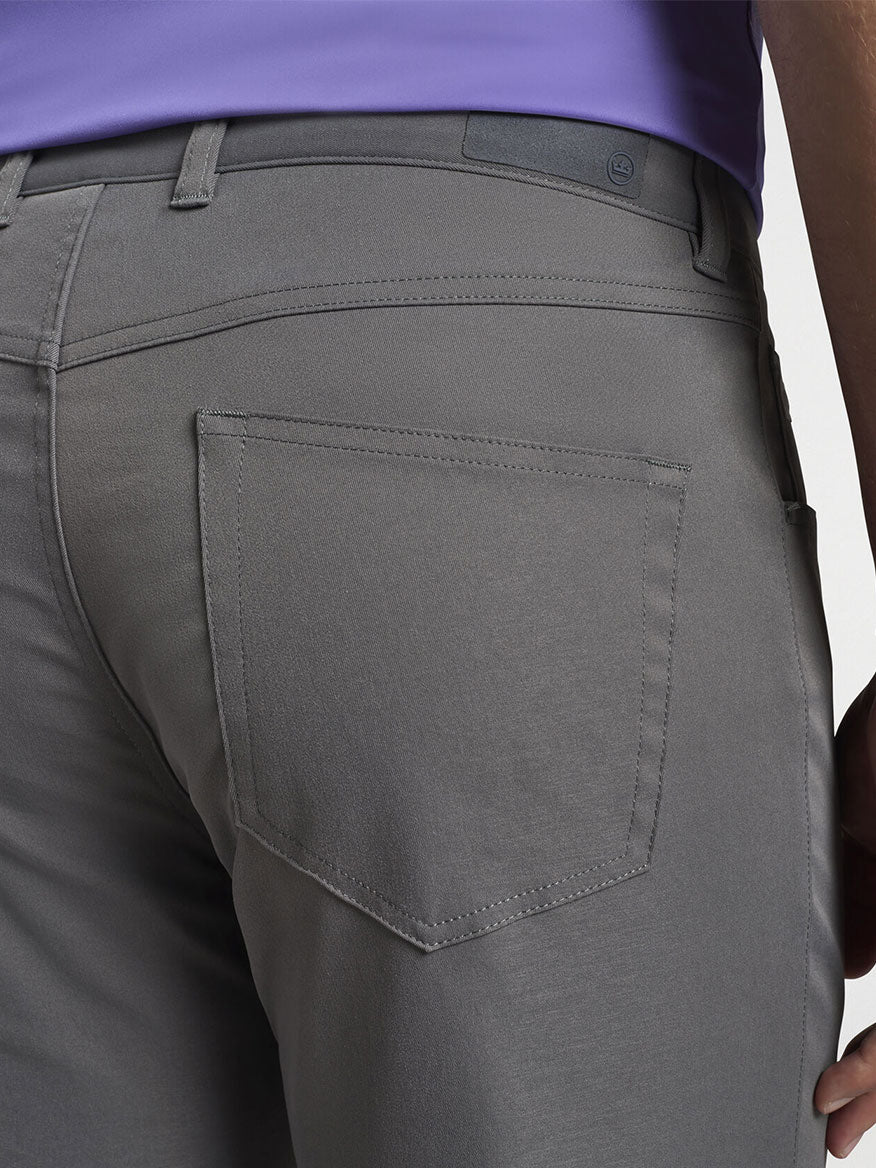 The back view of a man wearing Peter Millar Performance Five-Pocket Pant in Iron.