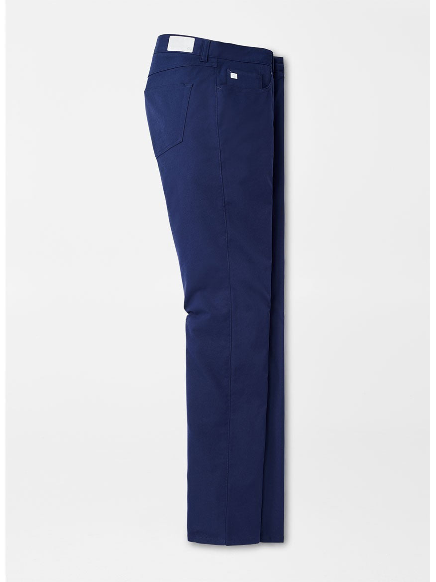 Side view of folded Peter Millar Performance Five-Pocket Pant in Navy with front and back pockets against a plain white background, ideal for PGA Tour players.