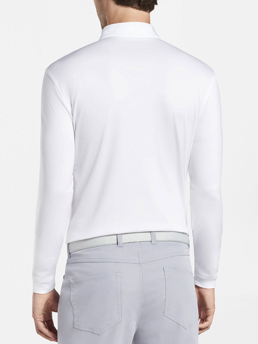 The back view of a man wearing a Peter Millar Solid Long-Sleeve Performance Jersey Polo in White.