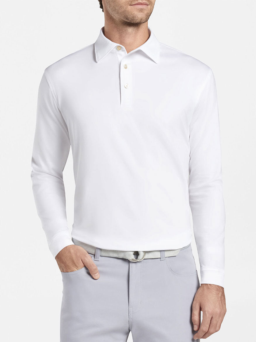 The man is wearing a Peter Millar Solid Long-Sleeve Performance Jersey Polo in White.