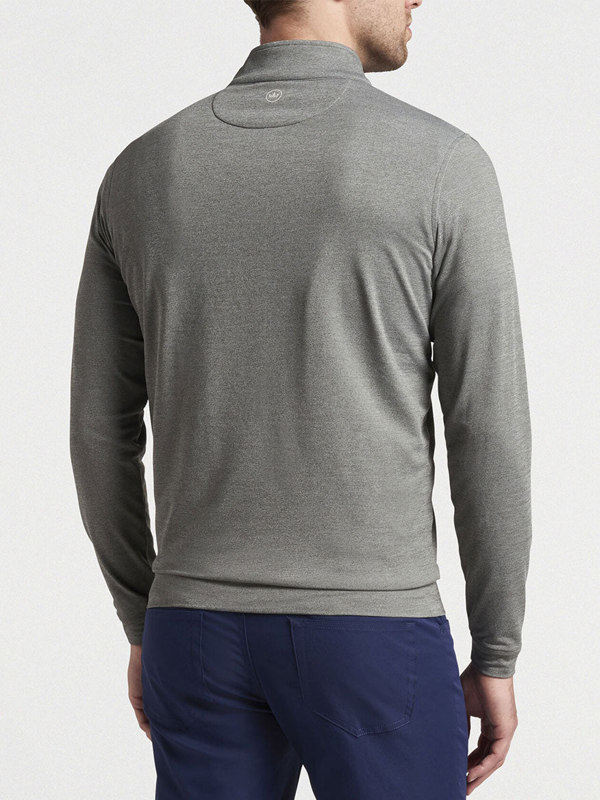 Man wearing a Peter Millar Perth Melange Performance Quarter-Zip in Smoke long-sleeved shirt viewed from the back.