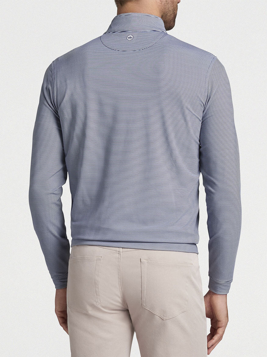Man wearing a Peter Millar Perth Sugar Stripe Performance Quarter-Zip in Navy/White and beige pants viewed from the back.