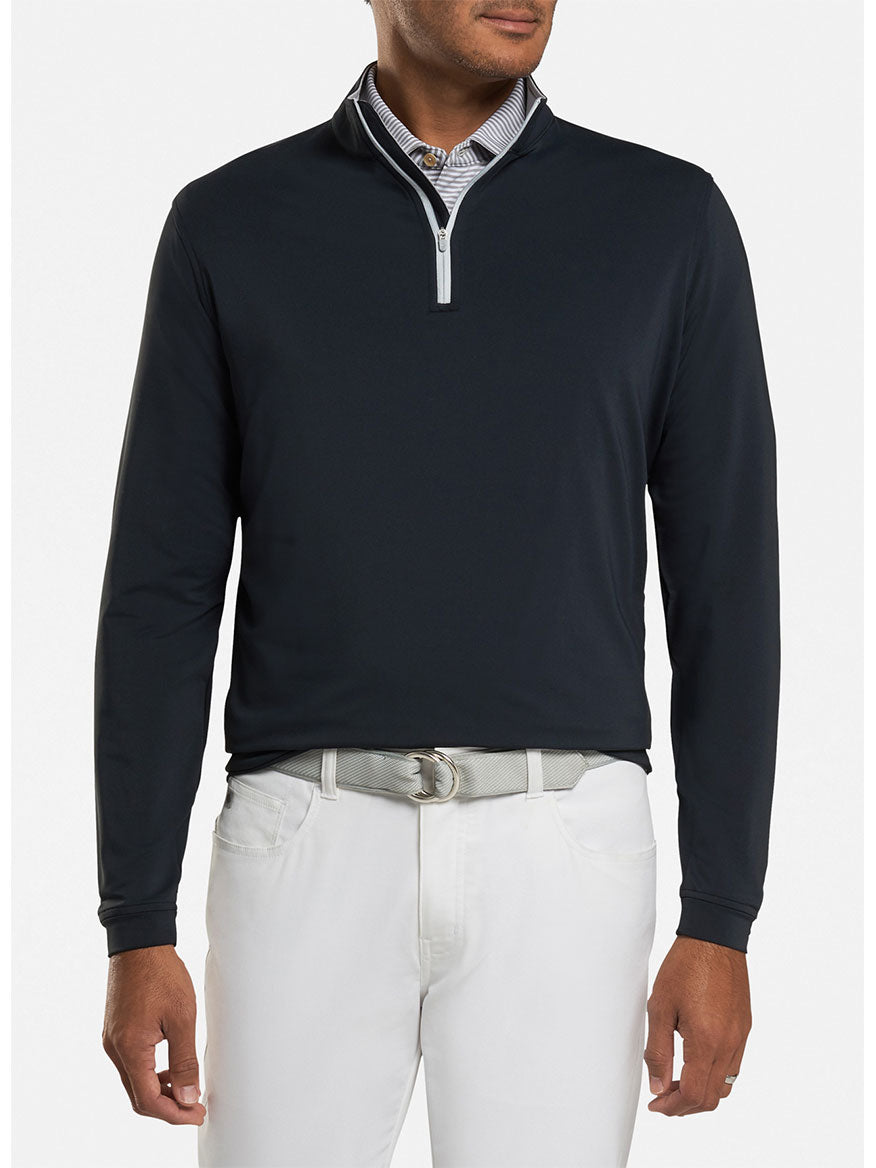 A man wearing a Peter Millar Perth Performance Quarter-Zip in Black sweater.