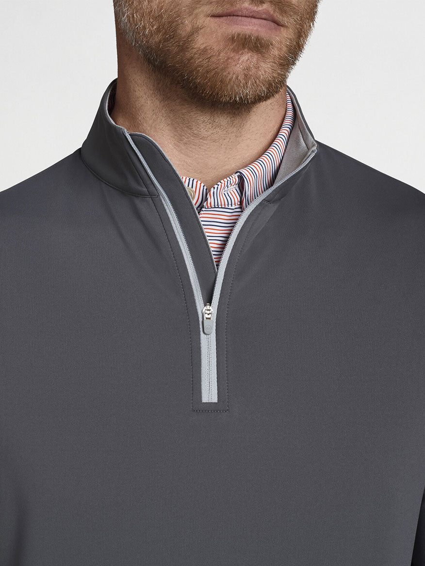 A man is wearing a Peter Millar Perth Performance Quarter-Zip in Iron sweater.