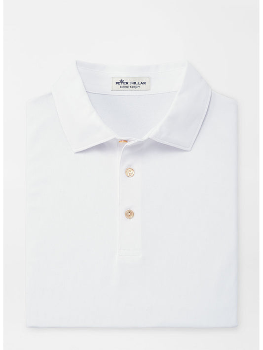 The Peter Millar Solid Performance Mesh Polo in White is neatly folded, showcasing its collar and three buttons. Made from moisture-wicking fabric, it’s displayed against a plain white background.