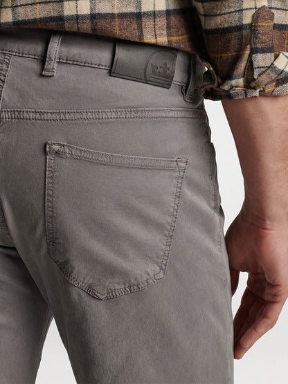 Close-up of a person wearing gray Peter Millar Wayfare Five-Pocket Pant in Nickel with a visible belt featuring a small logo.