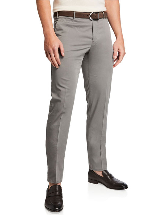 The person is wearing PT01 SilkOchino Stretch Trouser in Grey paired with a brown belt and black loafers, standing against a white background.