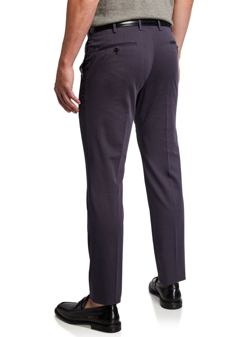 A person wearing dark-colored dress pants and black shoes, showcasing a chic look with PT01's SilkOchino Stretch Trouser in Navy, stands facing away from the camera.