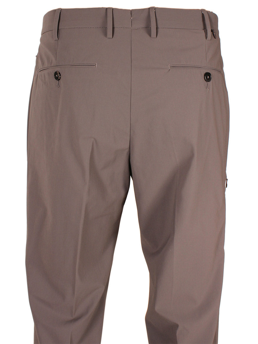 The image shows the back view of a pair of PT01 Kinetic Active Lux Trouser in Tan with belt loops, two rear pockets with button closures, and a clean, wrinkle-free fabric.