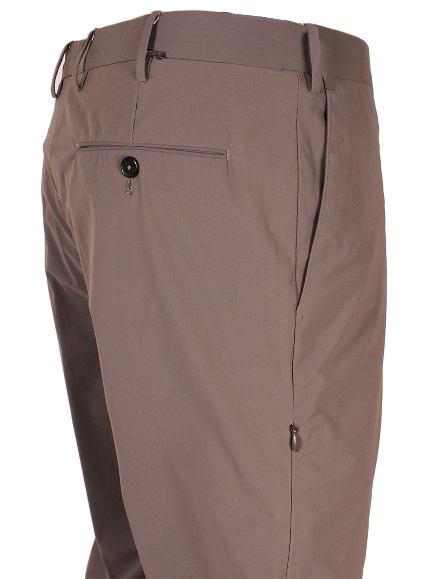 Close-up view of a pair of PT01 Kinetic Active Lux Trouser in Tan showcasing the waistband, belt loops, front zipper and button closure, and back pocket with a button.