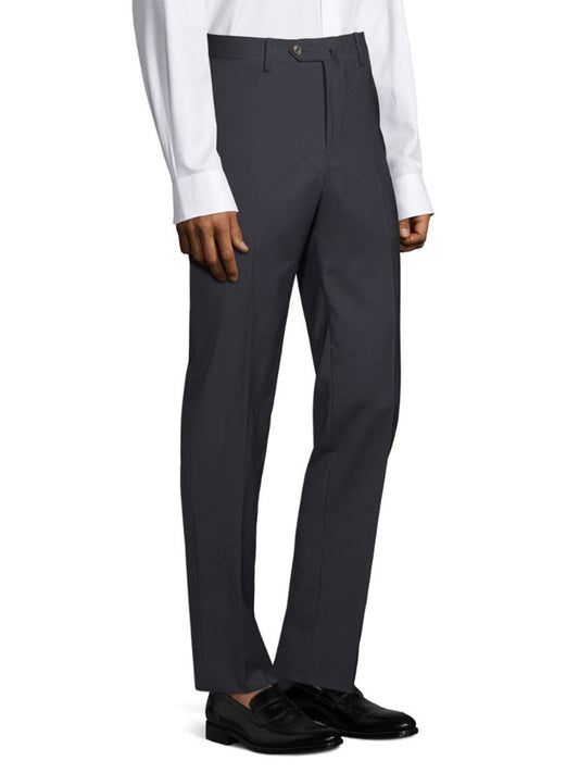 Person wearing PT01 Travel Wool Performance Trousers in Navy, a white long-sleeve shirt, and black dress shoes.