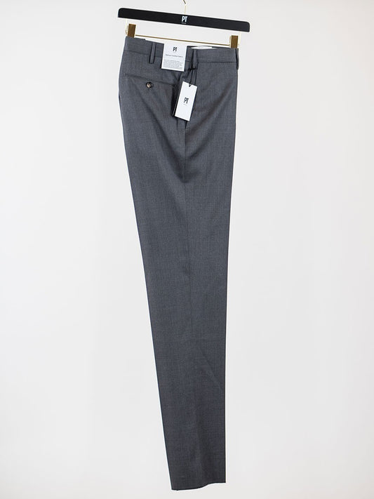 The PT01 Estrato 120s Lux Wool Twill Trouser in Light Grey Melange, with tags attached and elegantly displayed on a black and gold hanger, features a slim fit. Crafted from premium Italian natural stretch fabric, these trousers exemplify avant-garde manufacturing for exceptional comfort and style.