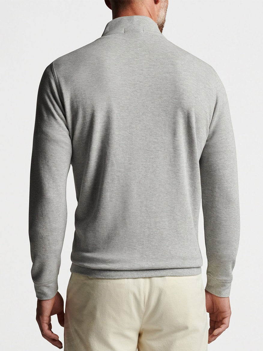 The back view of a man wearing a Peter Millar Crown Comfort Pullover in Light Grey, quarter-zip sweater.